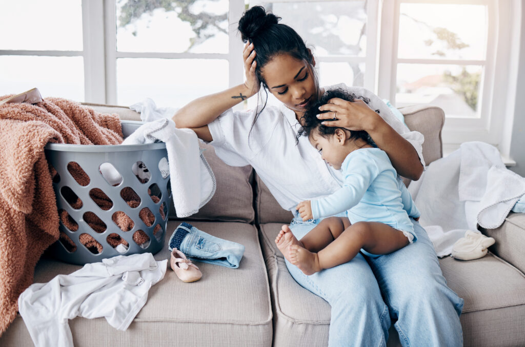 Mother and toddler have a respectful time-in moment of discipline while doing laundry