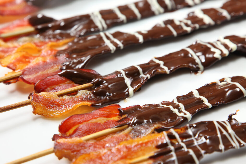 crispy Bacon dipped in dark chocolate on sticks