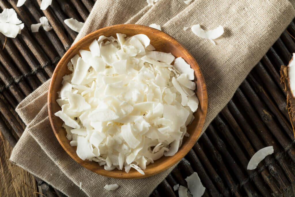 Raw Organic Coconut Flakes in a Bowl for Baking