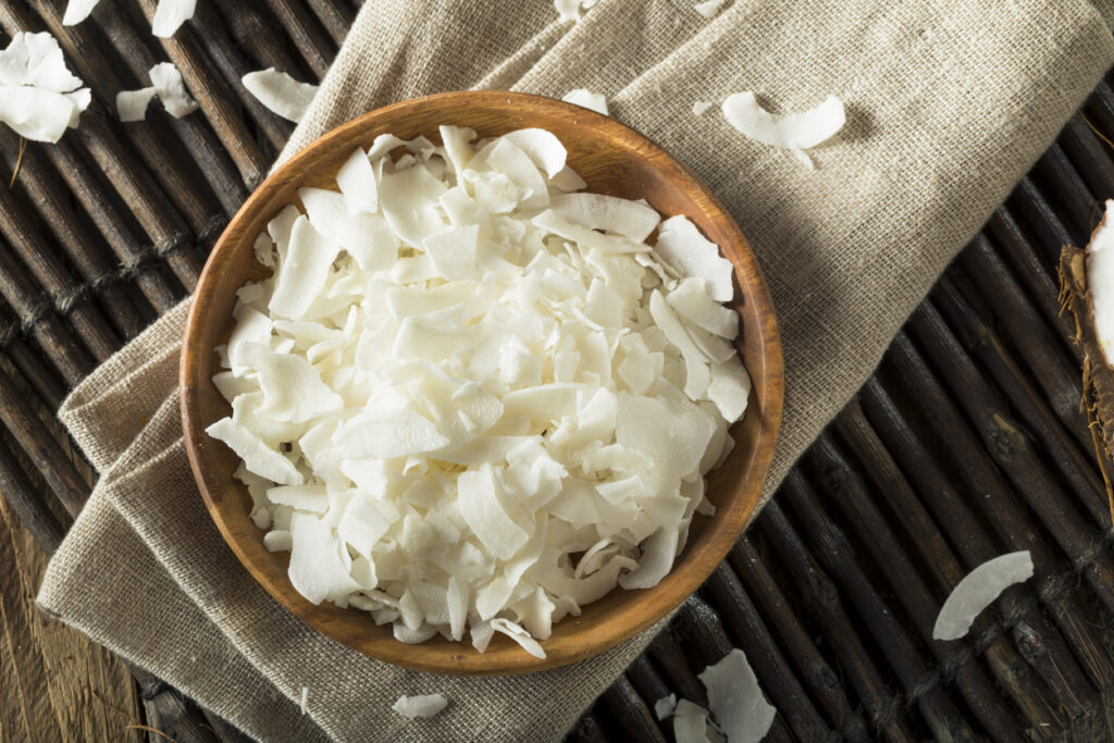 Raw Organic Coconut Flakes in a Bowl for Baking