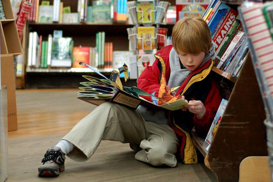 Young kid reading a book