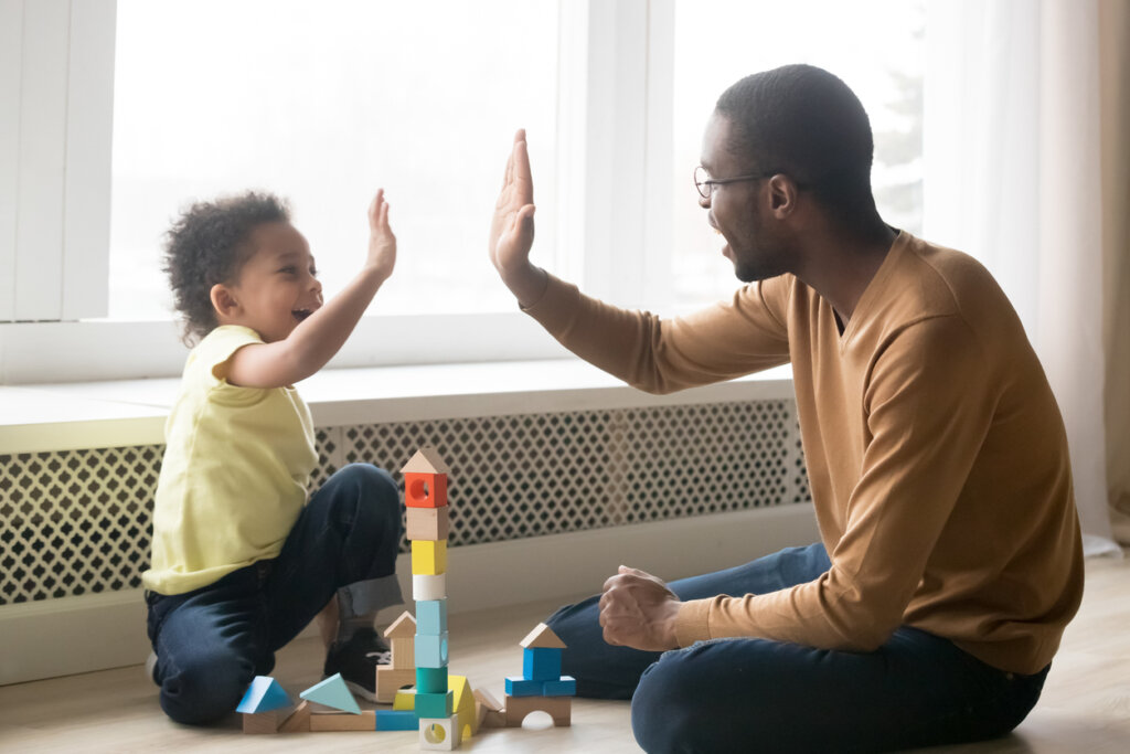 High five of baby and dad.