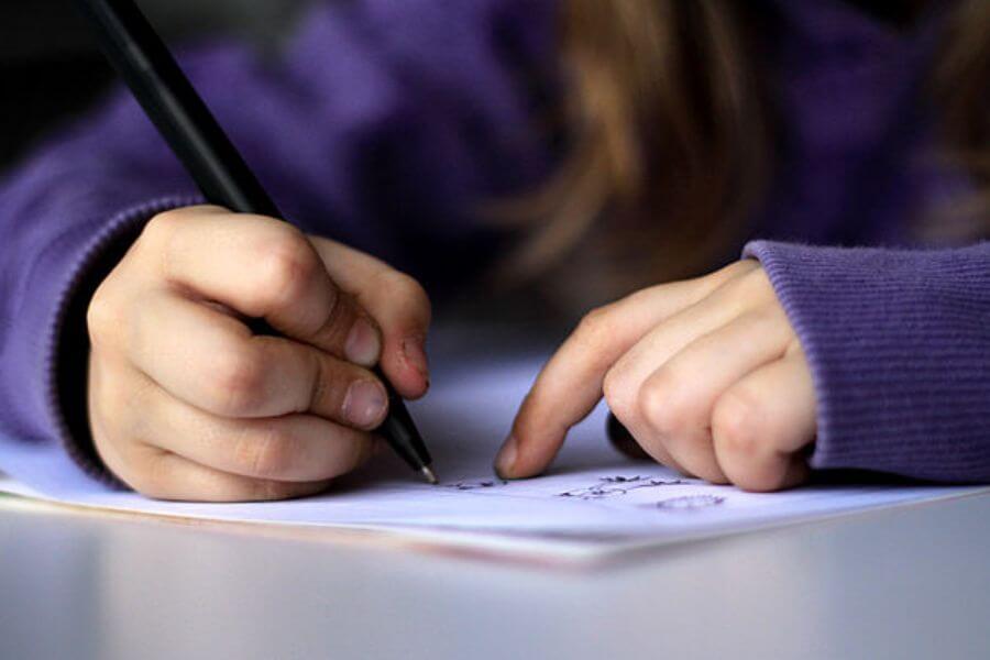 young kid writing 