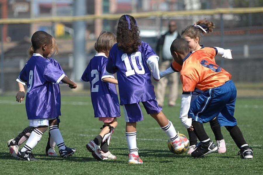 young girls palying soccer